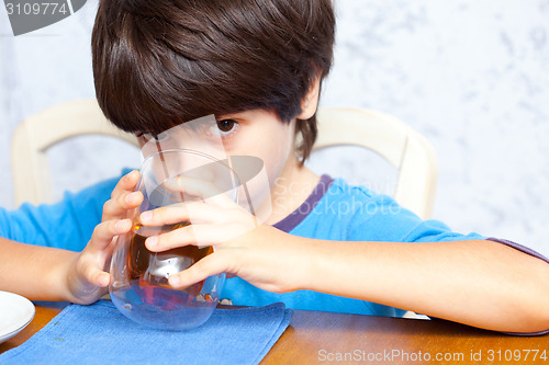 Image of child drinks morning beverage