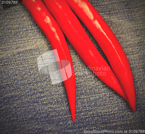 Image of red pepper on jeans background