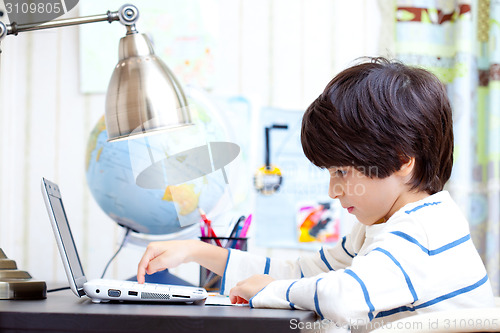 Image of young student working on a computer