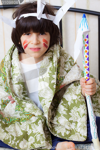 Image of boy playing with a indian spear