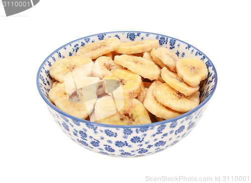 Image of Dried banana chips in a blue and white china bowl