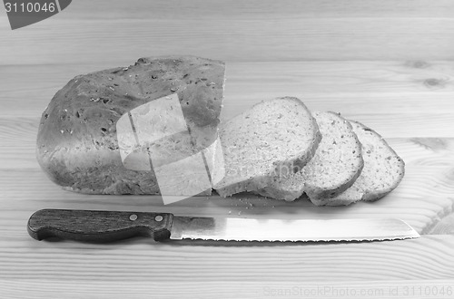 Image of Three slices cut from a loaf of bread with a knife