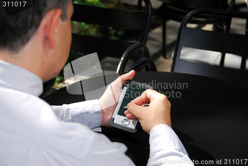 Image of Businessman hold pda