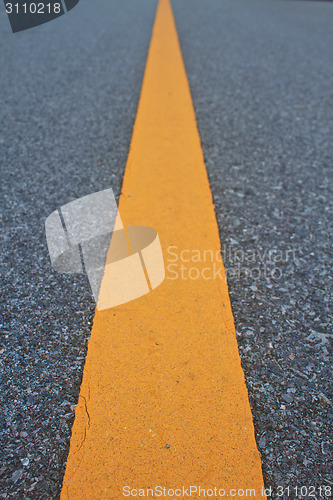 Image of asphalt road with marking lines and tire tracks