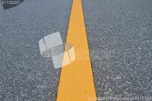 Image of asphalt road with marking lines and tire tracks