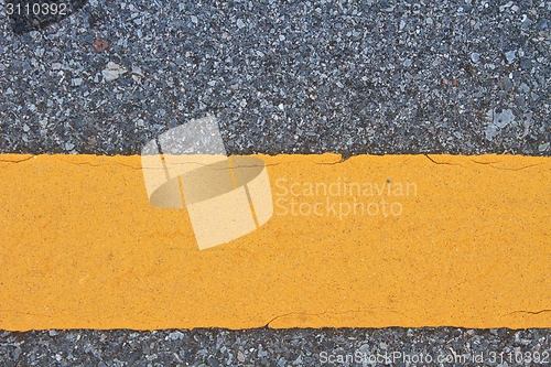 Image of asphalt road with marking lines and tire tracks