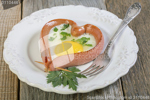 Image of Heart-shaped sausage and scrambled eggs.