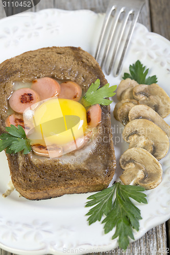 Image of Scrambled eggs with sausage and mushrooms.