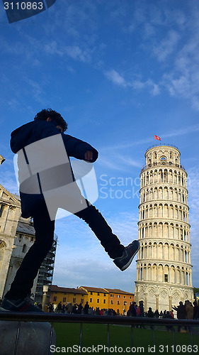 Image of Kid kicking and fixing Pisa Tower