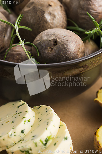 Image of  baked potatoes with herbs butter