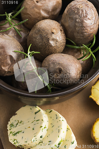 Image of  baked potatoes with herbs butter