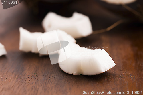 Image of close up of a coconut on a wooden background 