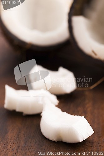 Image of close up of a coconut on a wooden background 