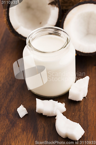 Image of Coconut Milk in a glass on dark wooden background