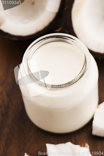 Image of Coconut Milk in a glass on dark wooden background