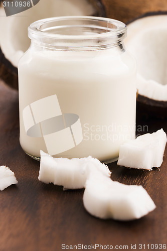 Image of Coconut Milk in a glass on dark wooden background