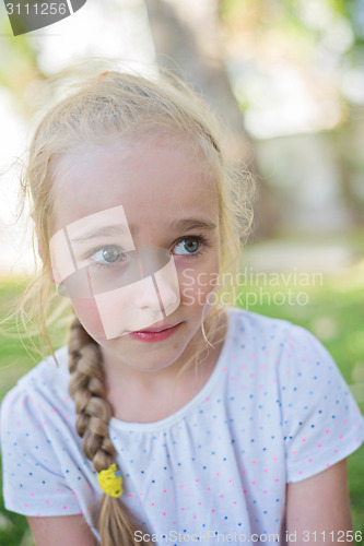 Image of Beautiful little girl with big eyes outdoors