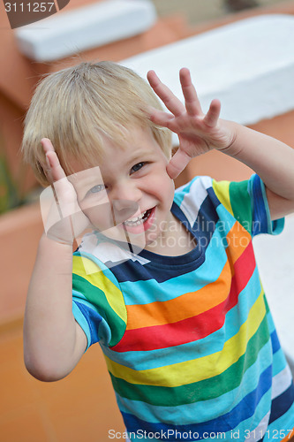 Image of Little boy playing hide-and-seek