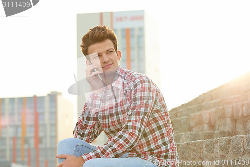 Image of Man with cellphone outdoors