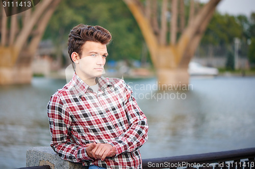 Image of Handsome man outdoors over urban background