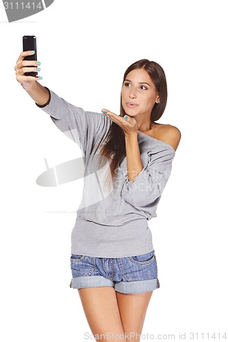 Image of Female taking pictures of herself at smart phone