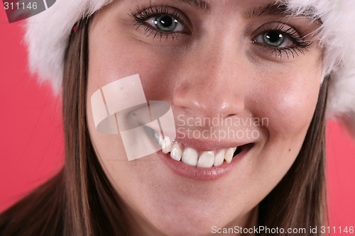 Image of Cute woman in fuzzy Christmas hat