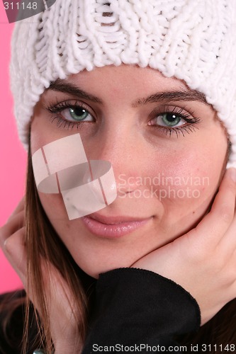 Image of Girl in wool hat on pink background