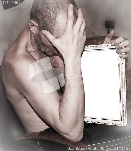 Image of  Man holds a picture