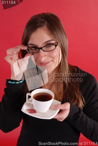 Image of Girl smiling holding tea and glasses