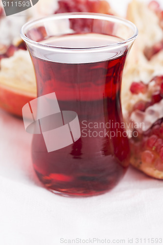 Image of Ripe pomegranates with juice on table