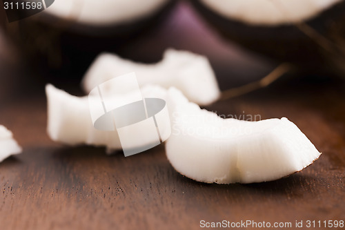 Image of close up of a coconut on a wooden background 
