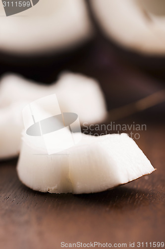 Image of close up of a coconut on a wooden background 