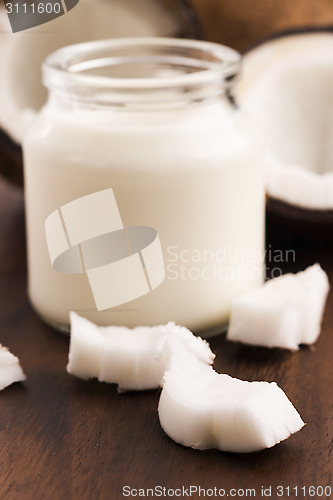 Image of Coconut Milk in a glass on dark wooden background