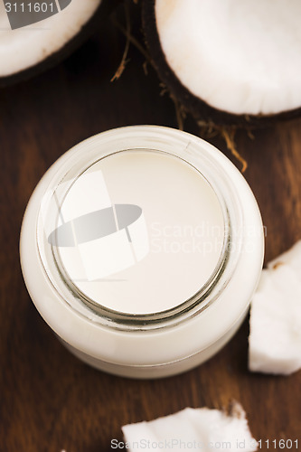 Image of Coconut Milk in a glass on dark wooden background