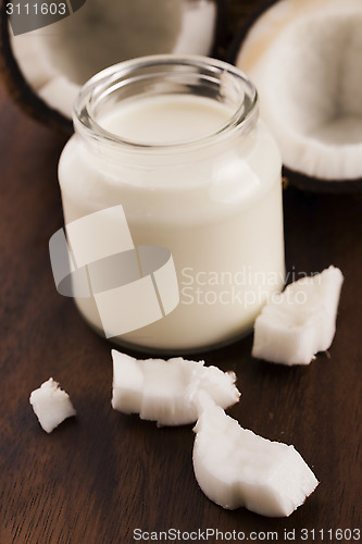 Image of Coconut Milk in a glass on dark wooden background