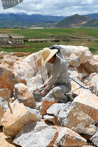 Image of Man chiseling stones for temple