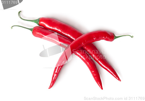 Image of Three red chili peppers crisscross