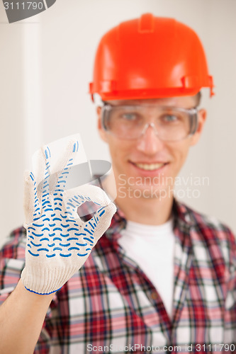 Image of repairman making a perfect gesture with his gloved hand