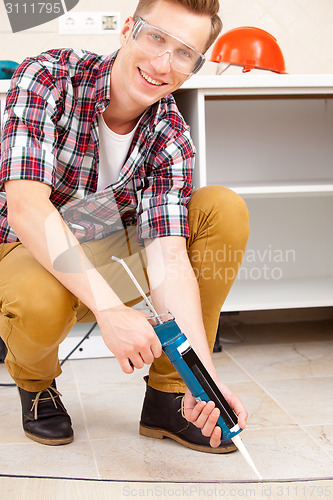 Image of  worker repairing the floor