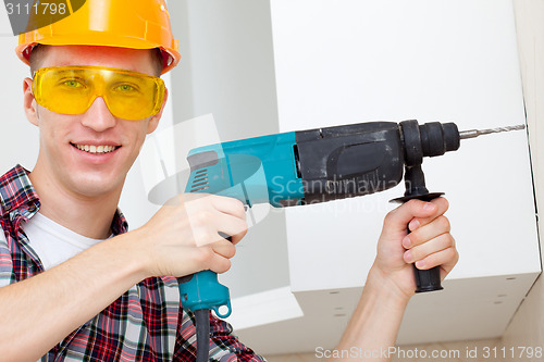 Image of smiling worker with rock-drill