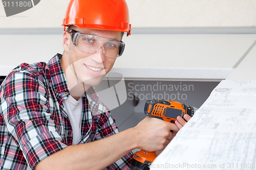 Image of repairman with electric drill