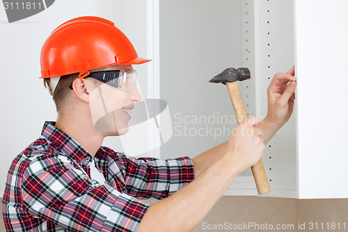 Image of worker with a hammer