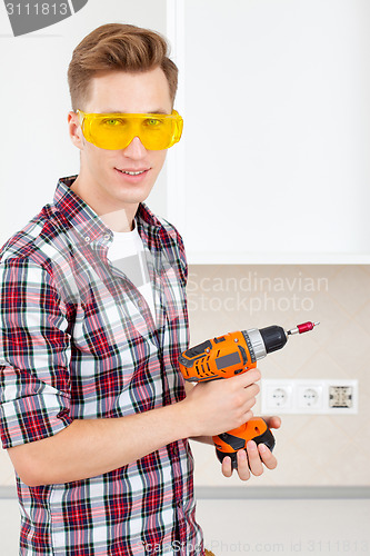 Image of smiling builder with a dril