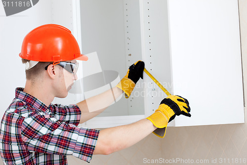 Image of repairman with a tape measure