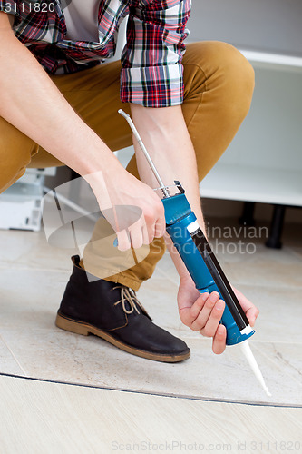 Image of worker repairing the floor