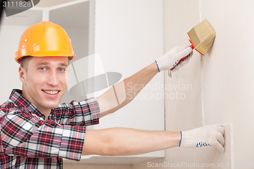 Image of young worker with paint brush