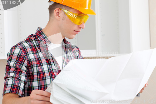 Image of builder with repair plan