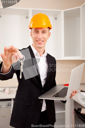 Image of engineer showing apartment  keys