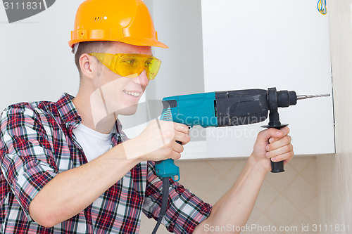 Image of smiling worker with rock-drill