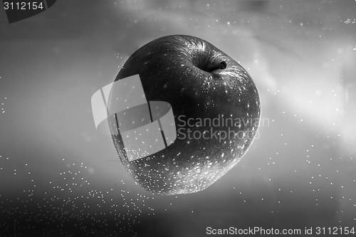 Image of Small apple in see trough water